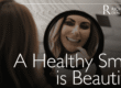female patient smiling in the mirror