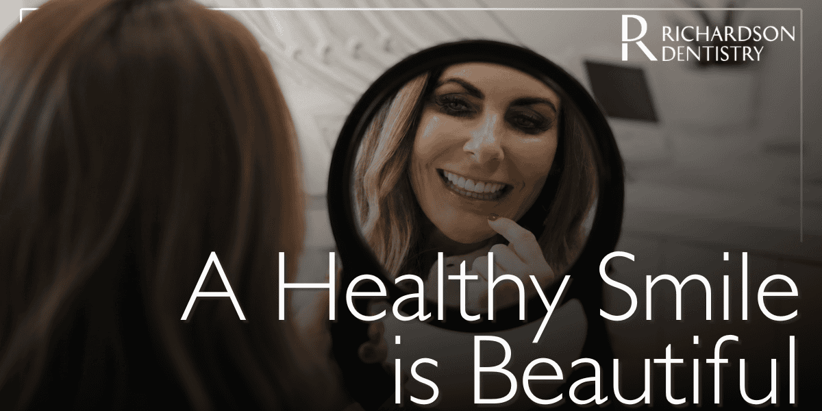 female patient smiling in the mirror
