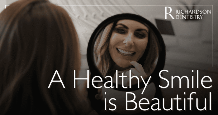 A Healthy Smile is Beautiful female patient smiling in the mirror